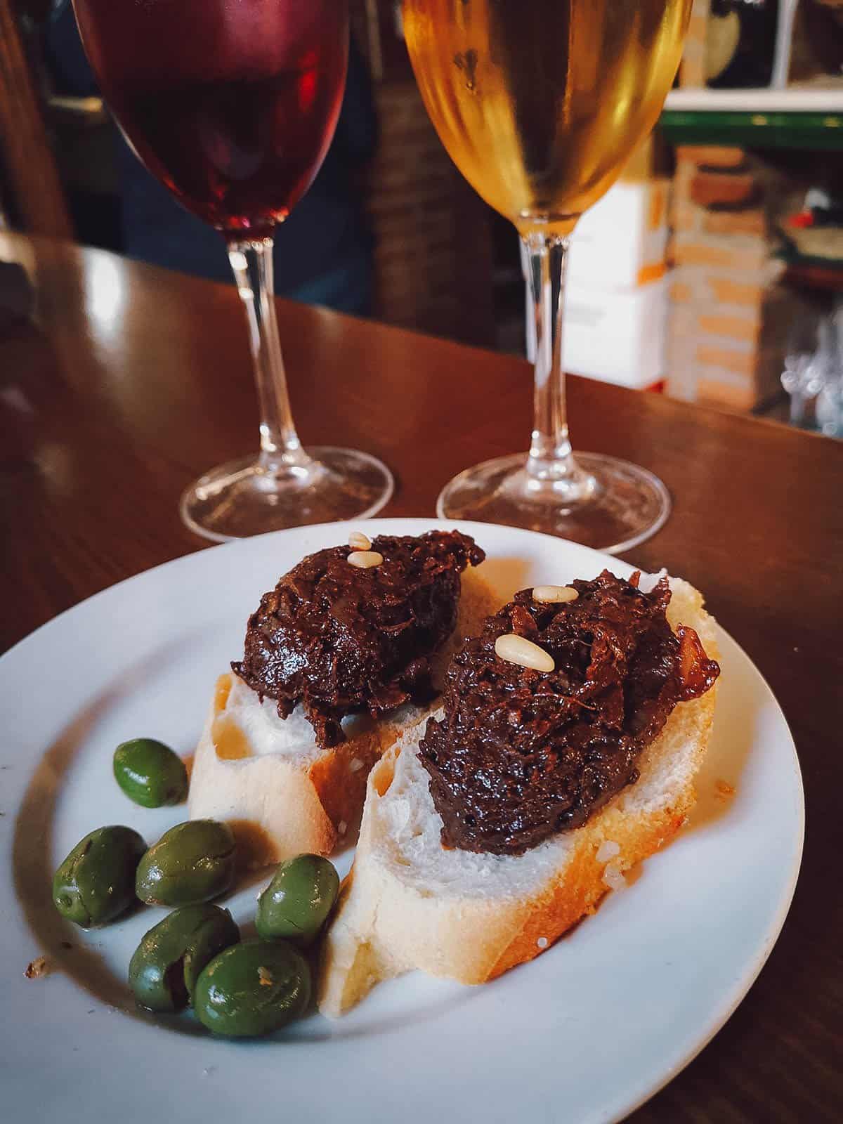 Morcilla with white and red wine at a popular Spanish tapas bar in Granada